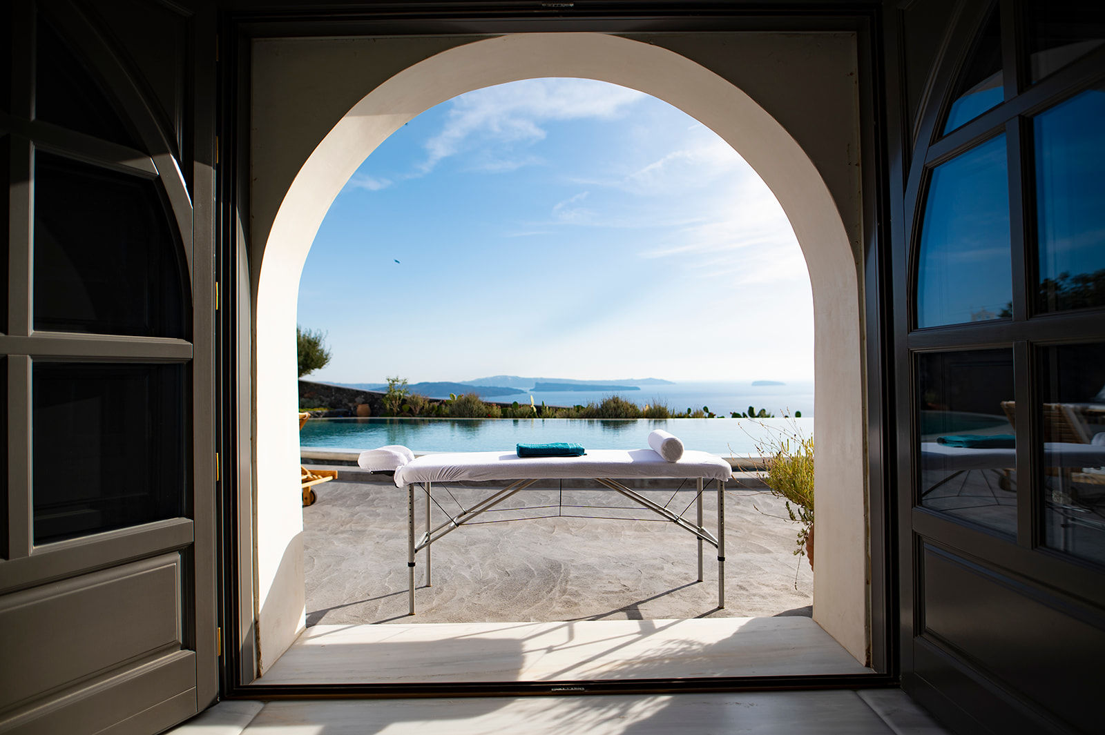 Massage table at a Santorini villa, setting the scene for a relaxing Anti Stress Massage Treatment by Soma Rei Wellness.