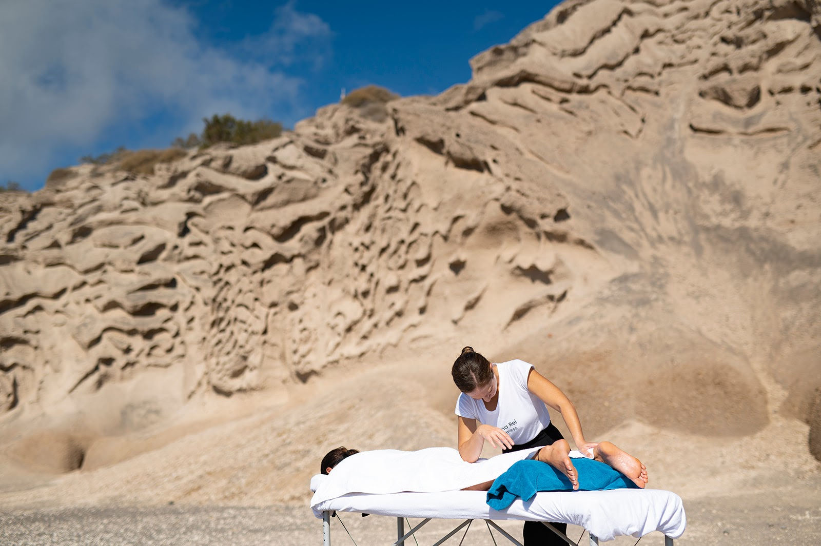 Santorini Mobile Deep Tissue Massage: Therapist in Vlychada's unique landscape.