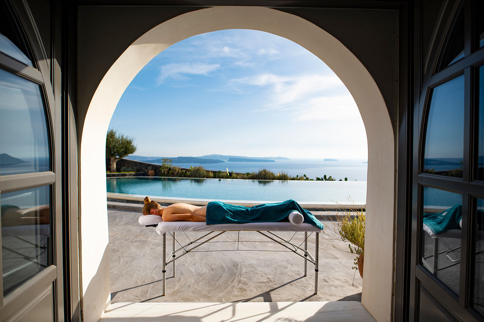 Relaxed woman after a rejuvenating mobile jet lag massage in Santorini by Soma Rei Wellness.