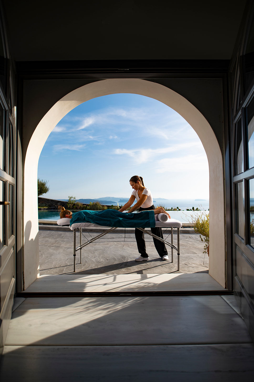 Santorini Mobile Massage: Therapist providing an open air soothing deep tissue massage at a villa with pool in Oia.